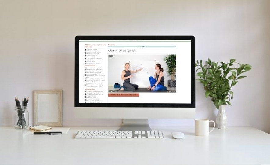 A desktop computer with a section from yogacourse.com 200 hour course